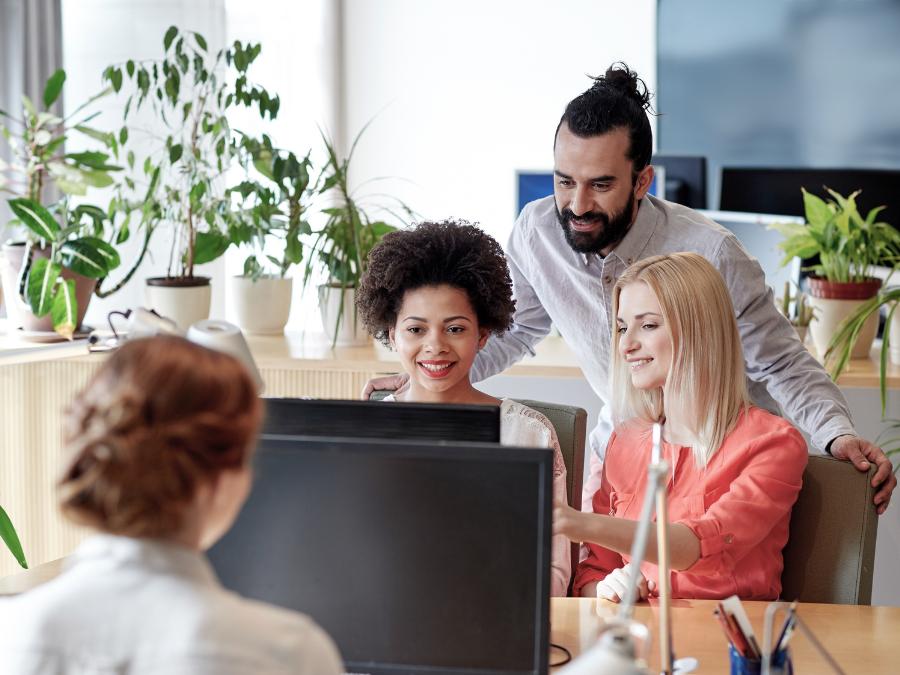 Employees working in Miami office with optimized and latest technology computer purchased after reading Prime Tech Support Computer guide