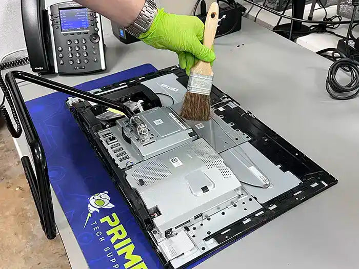 All in One computer cleaning performed at Prime Tech Support Lab in Miami. Our tech is using a air cleaning device to keep the unit free of dust to avoid overheating.